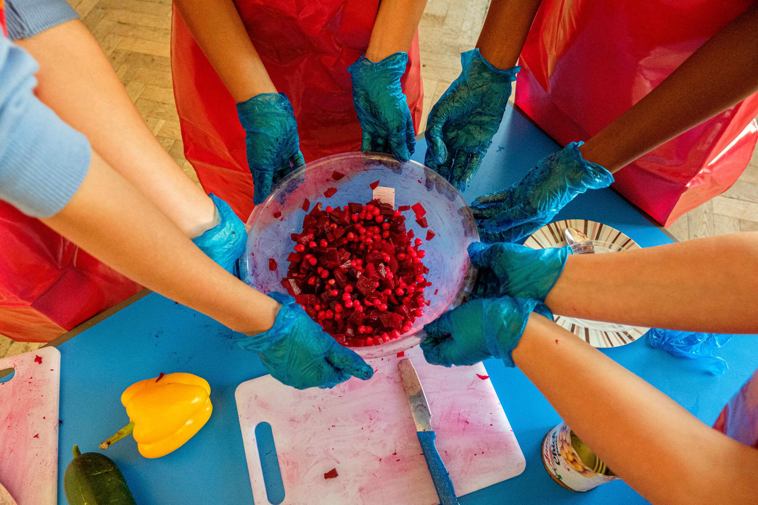 Children's hands holding bowl with beetroot